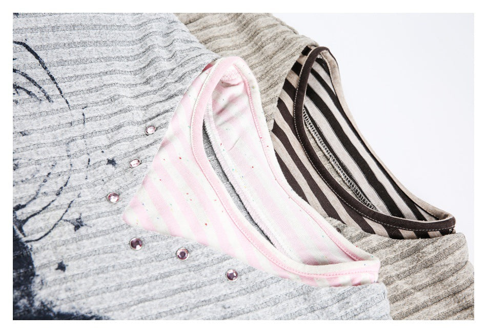 Close-up of layered gray ribbed tops showing pink striped and dark brown striped necklines with small decorative studs.