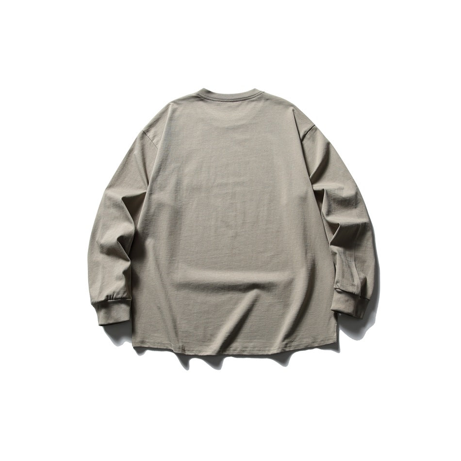 Back view of a taupe long-sleeve crewneck shirt with ribbed cuffs.