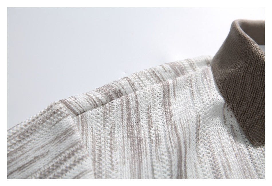 Close-up of the shoulder seam and taupe collar on an ivory striped openwork knit polo shirt.