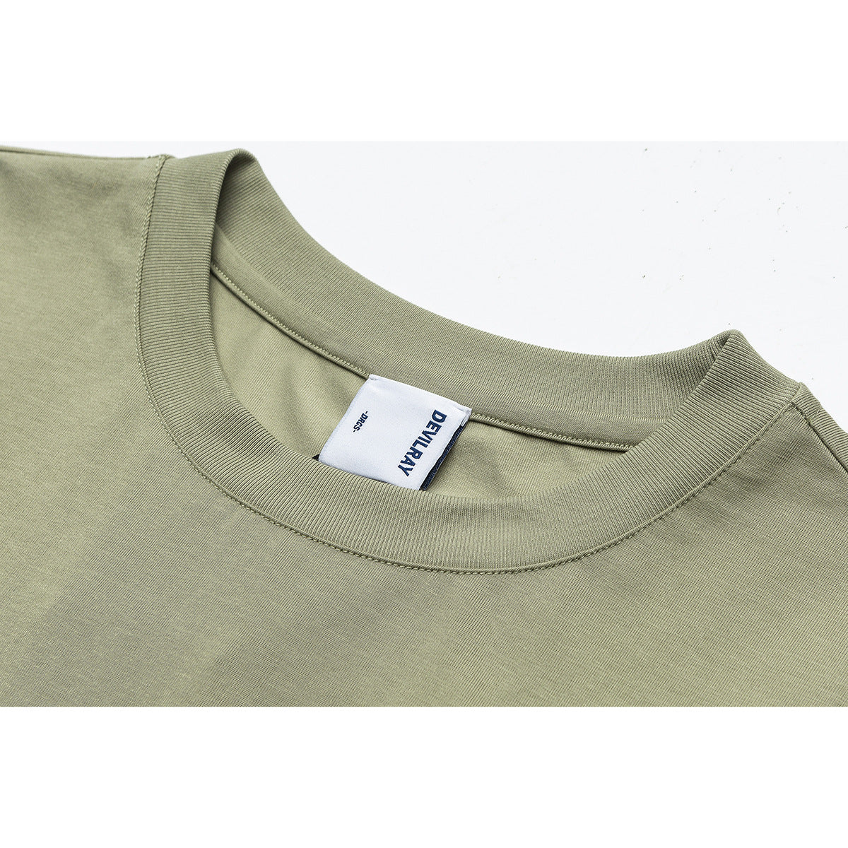 Close-up of an olive-green T-shirt crew neck and sewn-in white brand label.