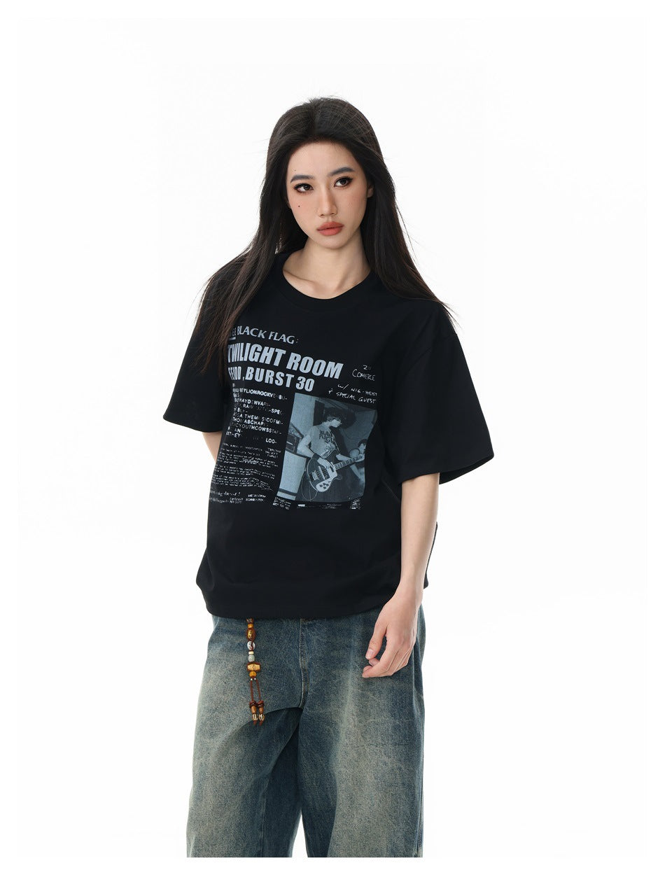 Model wearing an oversized black graphic T-shirt with wide-leg blue jeans, shown from the front.