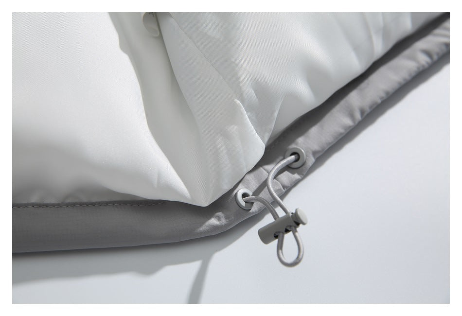 Close-up of the light gray jacket hem with eyelets and an elastic drawcord toggle.