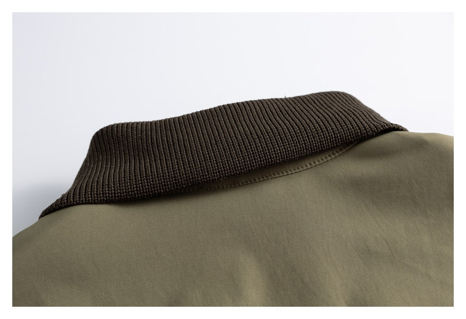 Close-up of the olive jacket collar with dark brown rib-knit trim.