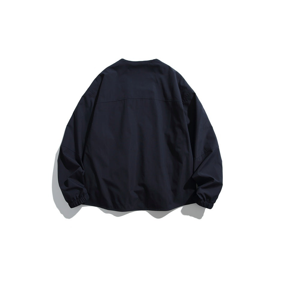 Navy jacket back view with yoke seam and elastic cuffs, flat lay