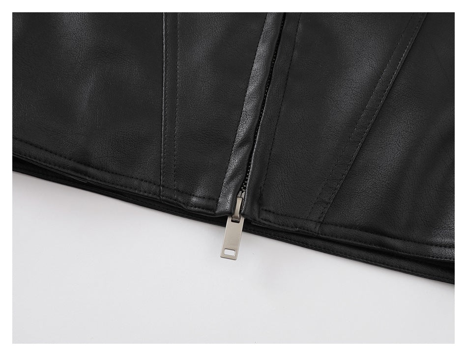 Close-up of a black jacket's lower edge and central metal zipper against a white background.