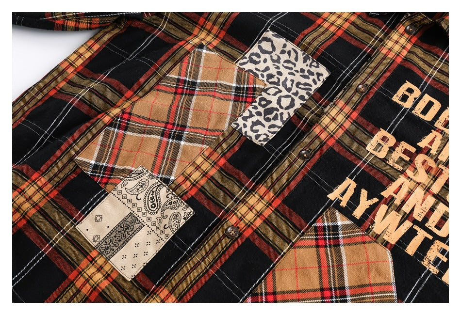 Close-up of a plaid shirt front with brown buttons and tan plaid, leopard-print and paisley patchwork.