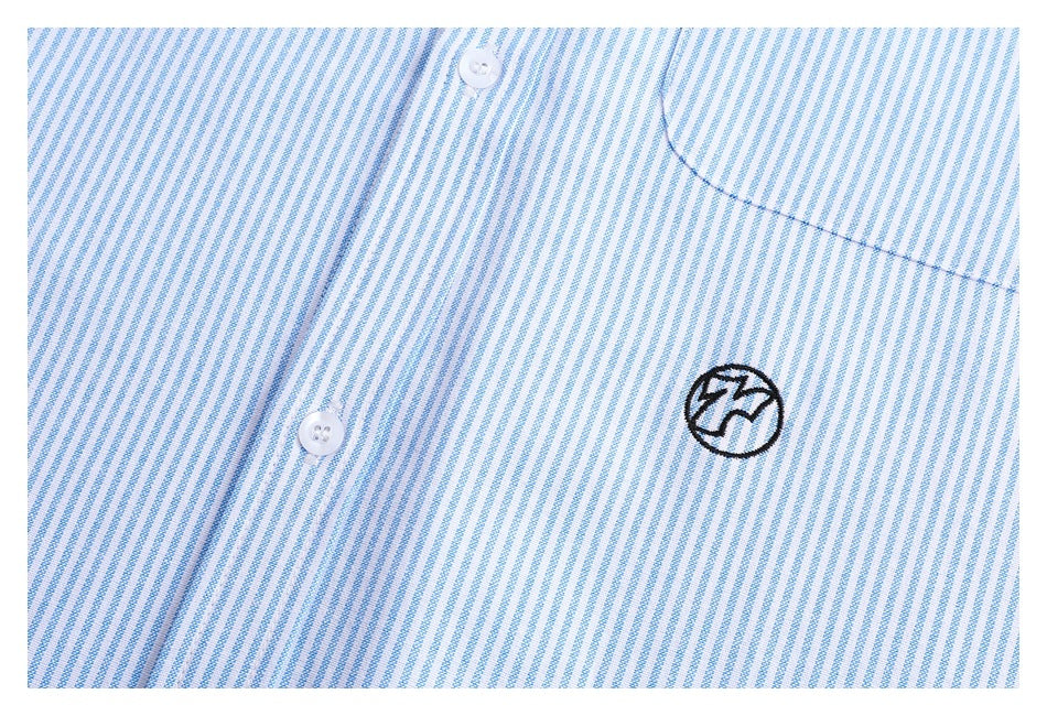 Close-up of a light blue and white striped shirt chest with white buttons and a small black embroidered emblem.