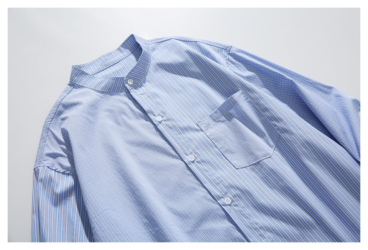 Close view of the front of a blue striped shirt, showing its band collar, buttons, chest pocket, and sleeves.