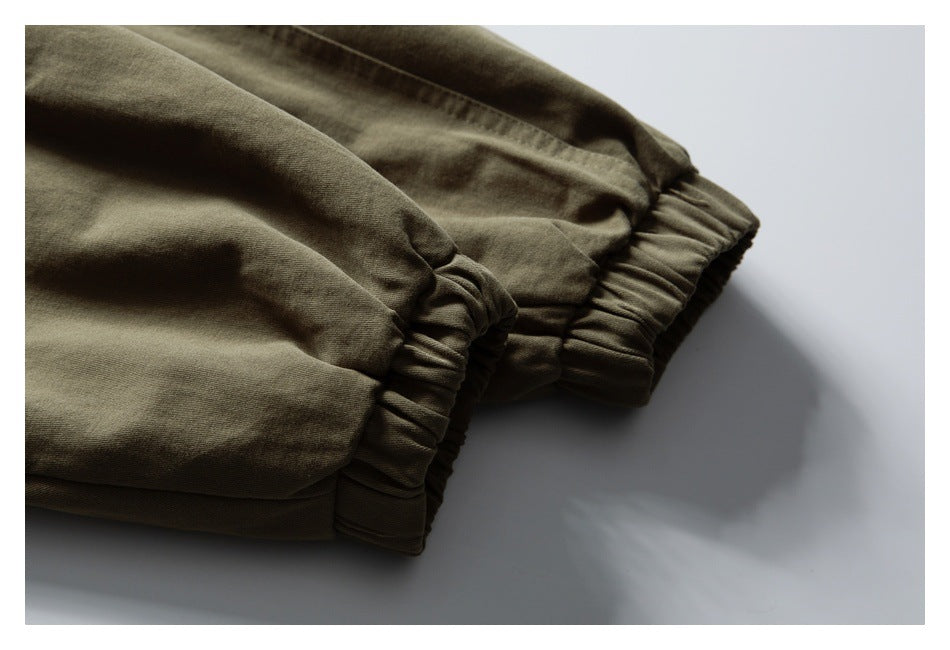 Close-up of the olive jacket's gathered elastic cuff.