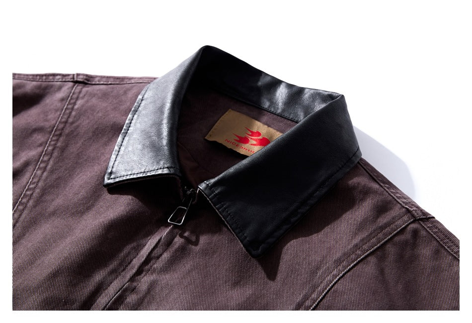 Close-up of a dark plum jacket collar in black material, with a tan neck label and front zipper.