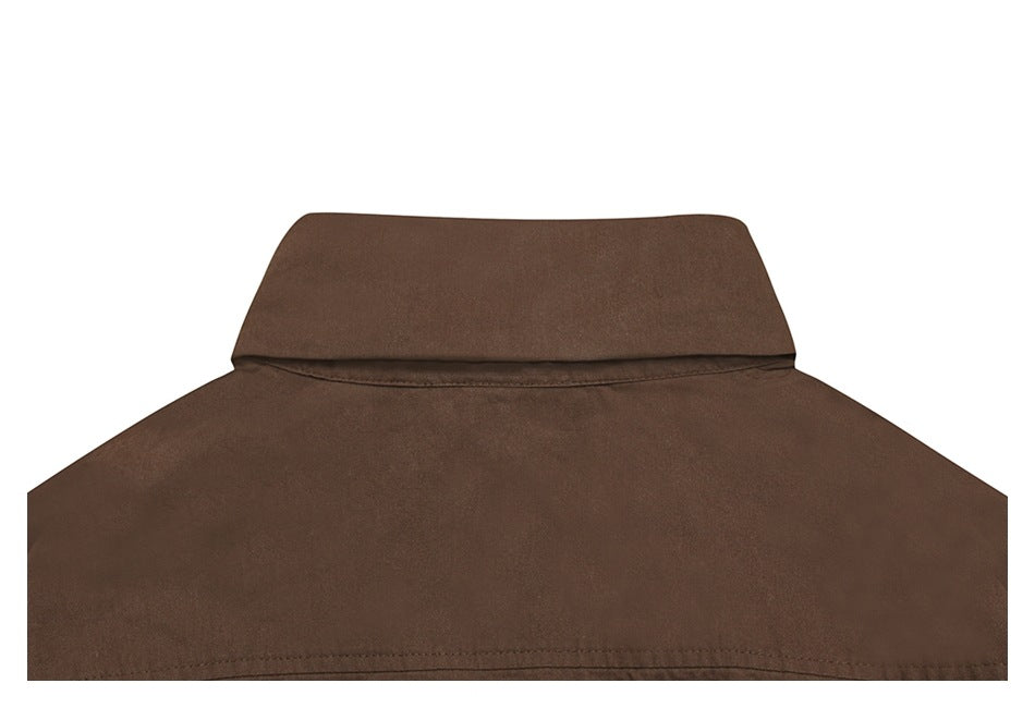 Close-up of the back of a brown shirt, showing its collar and upper yoke seam.