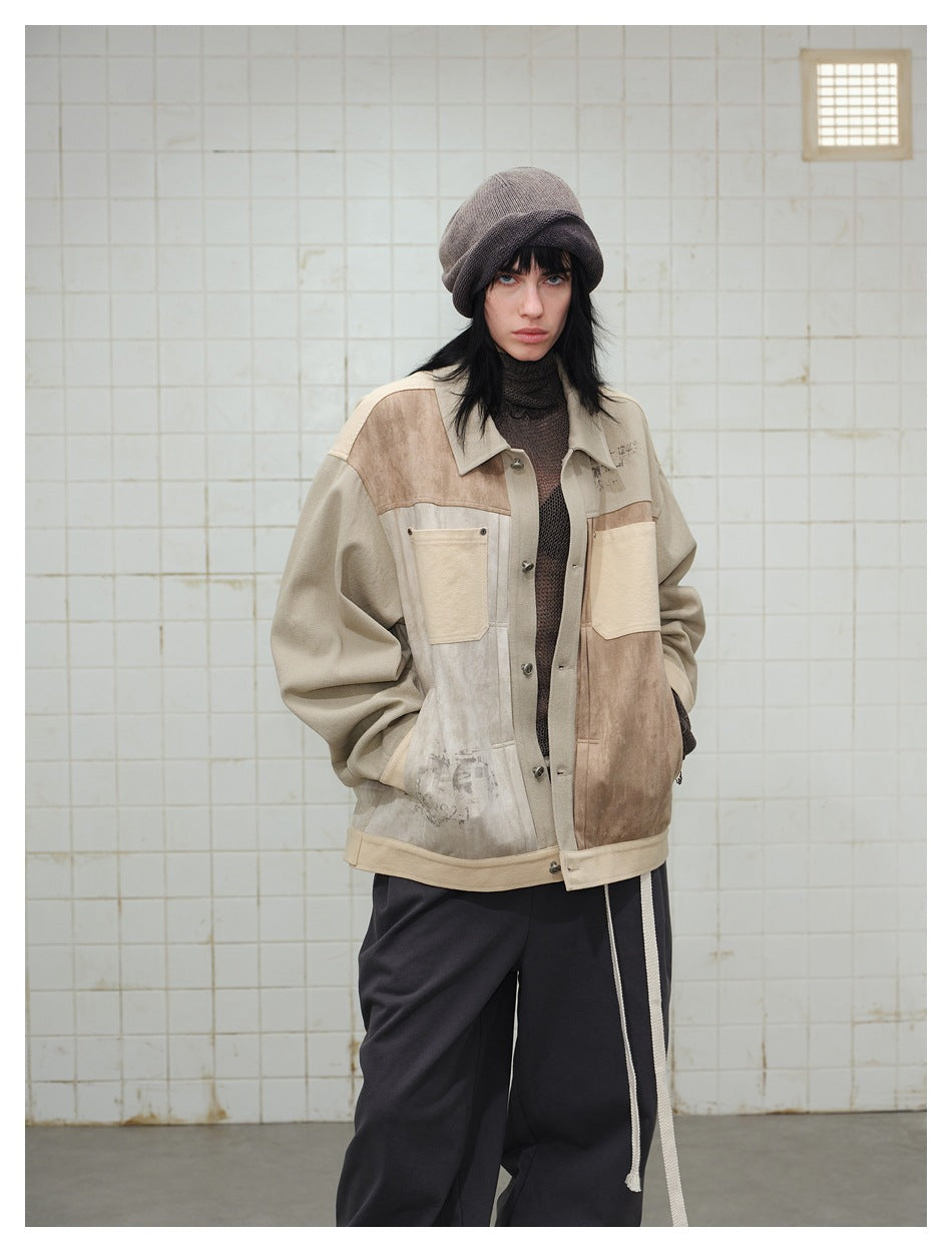 Front view of a model in a beige and brown patchwork jacket with chest pockets, paired with dark trousers.