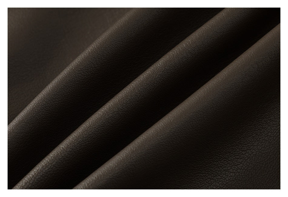 Close-up of dark brown, pebbled leather-like material draped in soft folds.