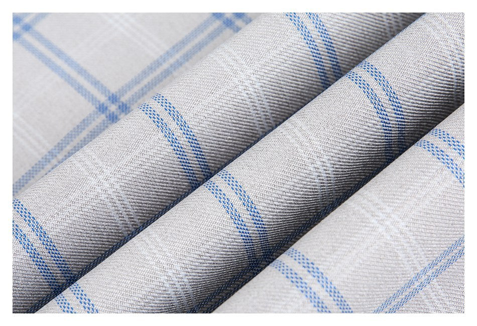 Close-up of light gray woven fabric with thin blue plaid stripes, folded into diagonal ridges.