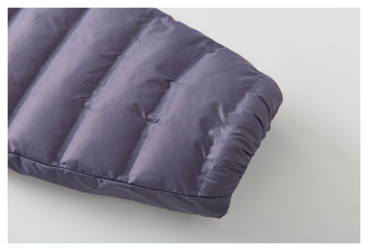 Close-up of a padded lavender-gray jacket sleeve with stitched channels and a rounded cuff.