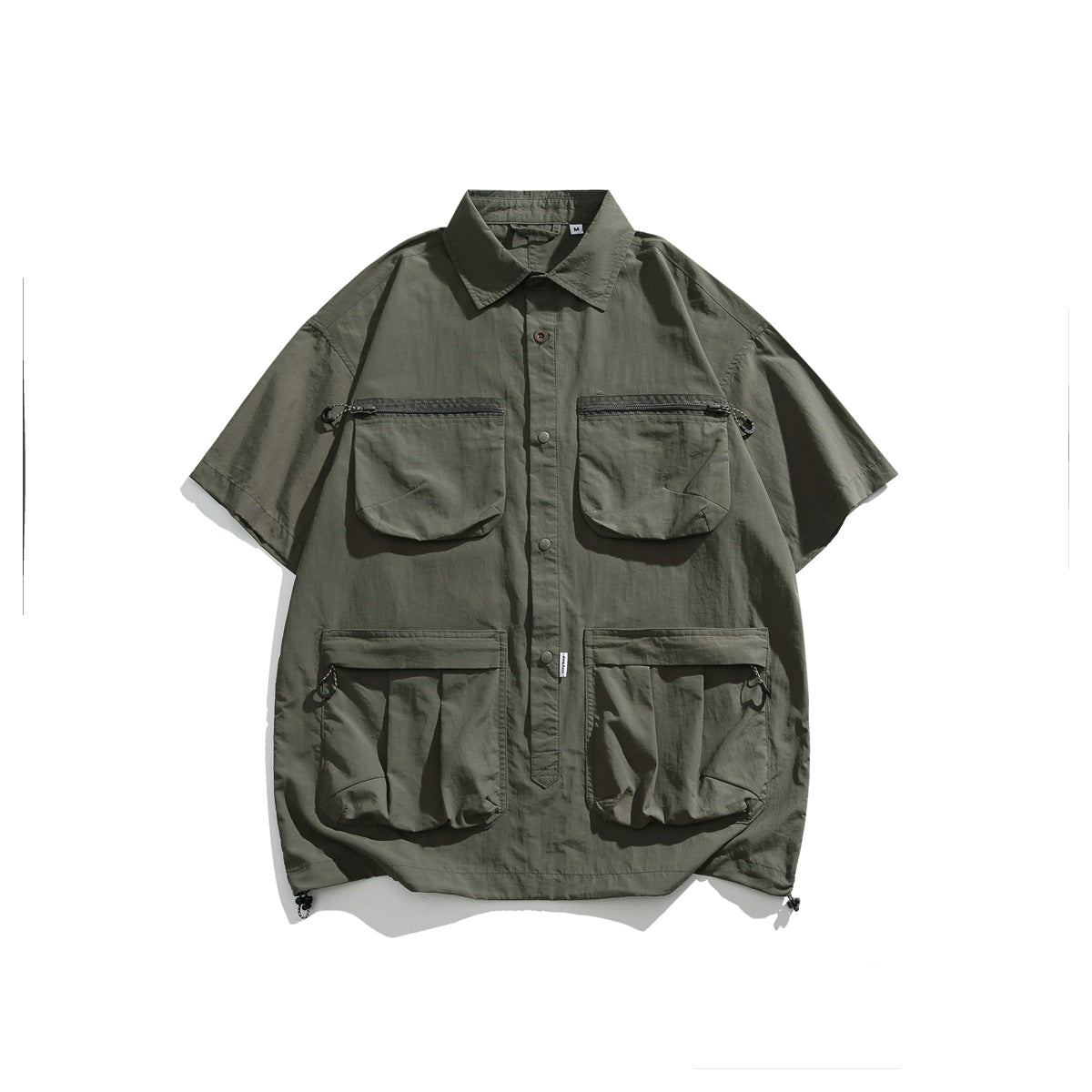 Army green short-sleeve utility shirt flat lay with four pockets and drawcord hem toggles