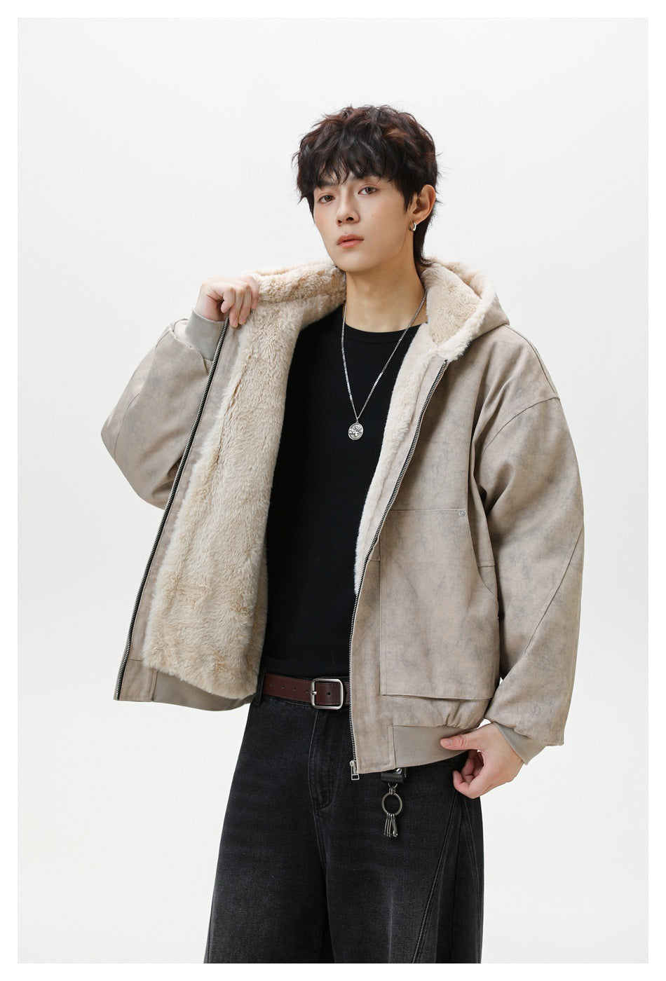 Model holds open a taupe hooded jacket to show its cream plush lining and front zipper.
