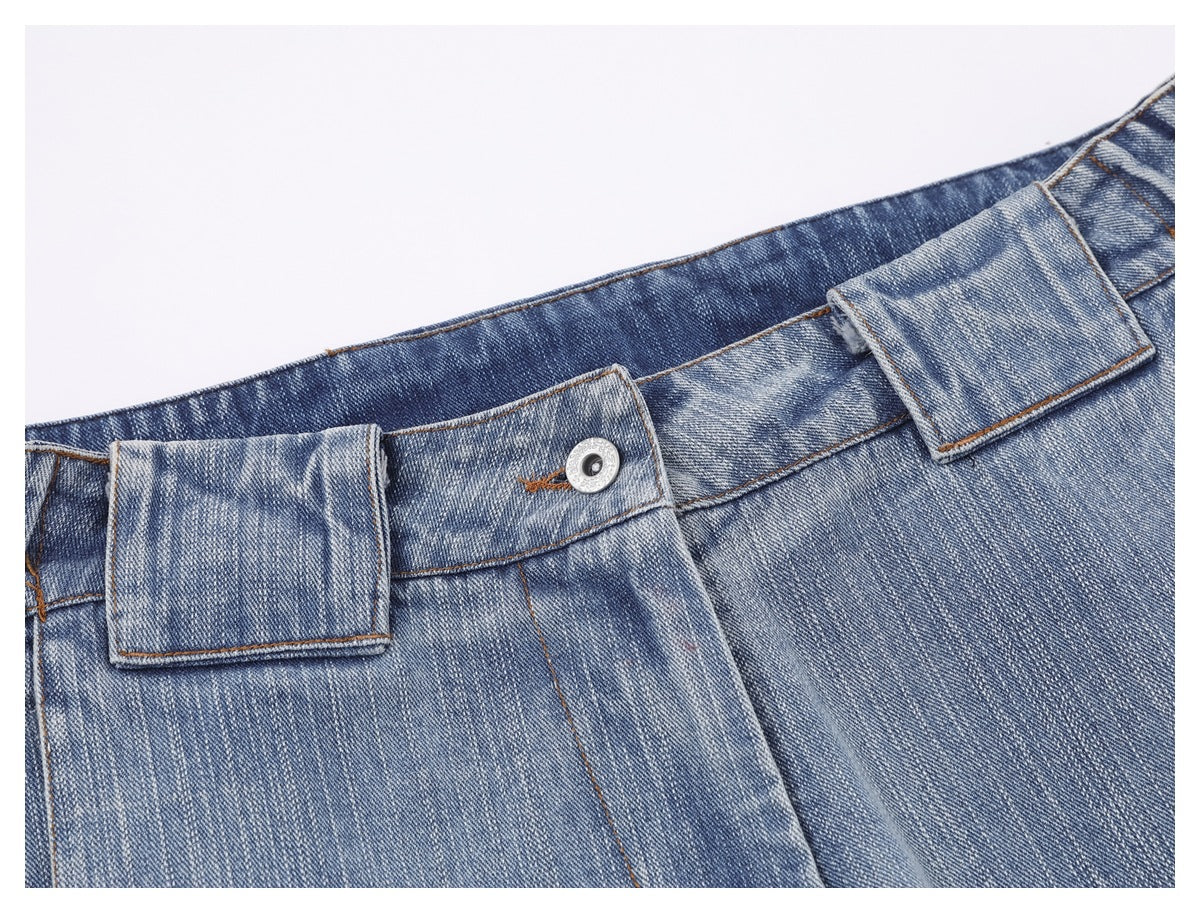 Close-up of faded blue jeans showing the waistband, belt loops, and metal button.