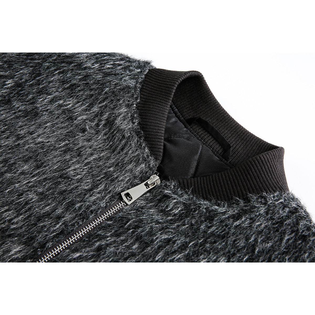 Close-up of a charcoal gray fuzzy jacket with a black ribbed collar, dark lining, and silver front zipper.