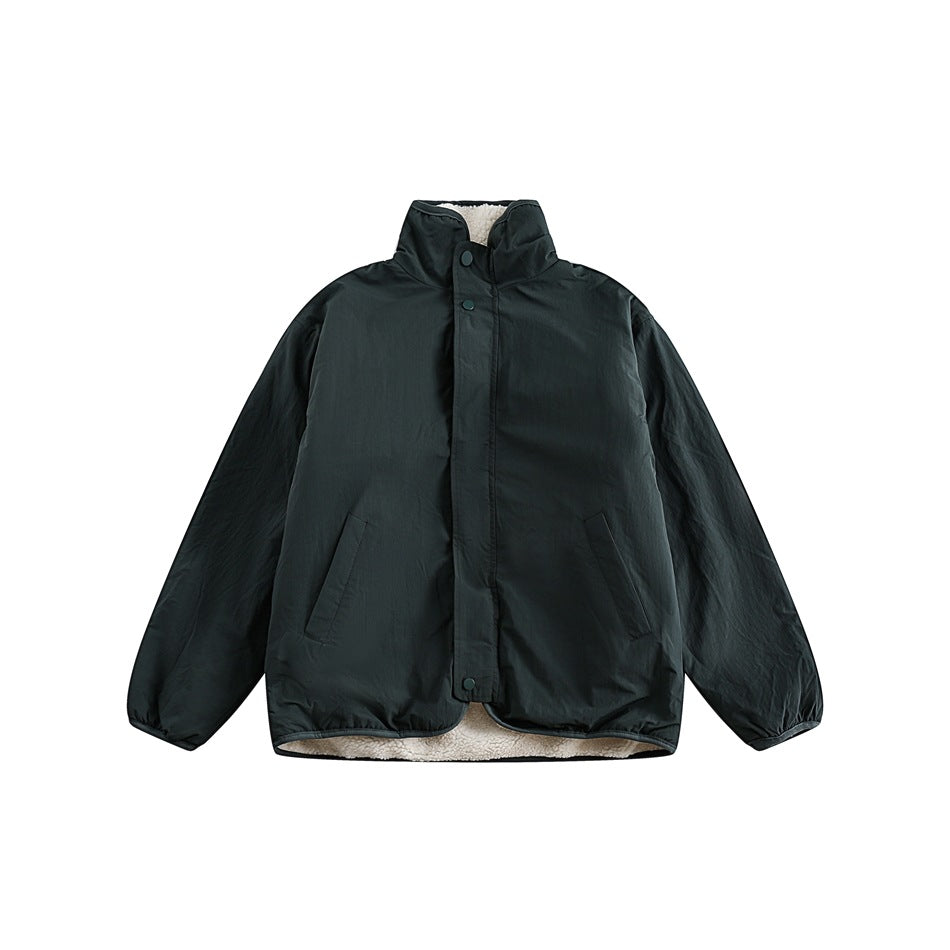 Dark green stand-collar jacket flat lay with snap placket, side pockets and cream fleece showing at hem and collar