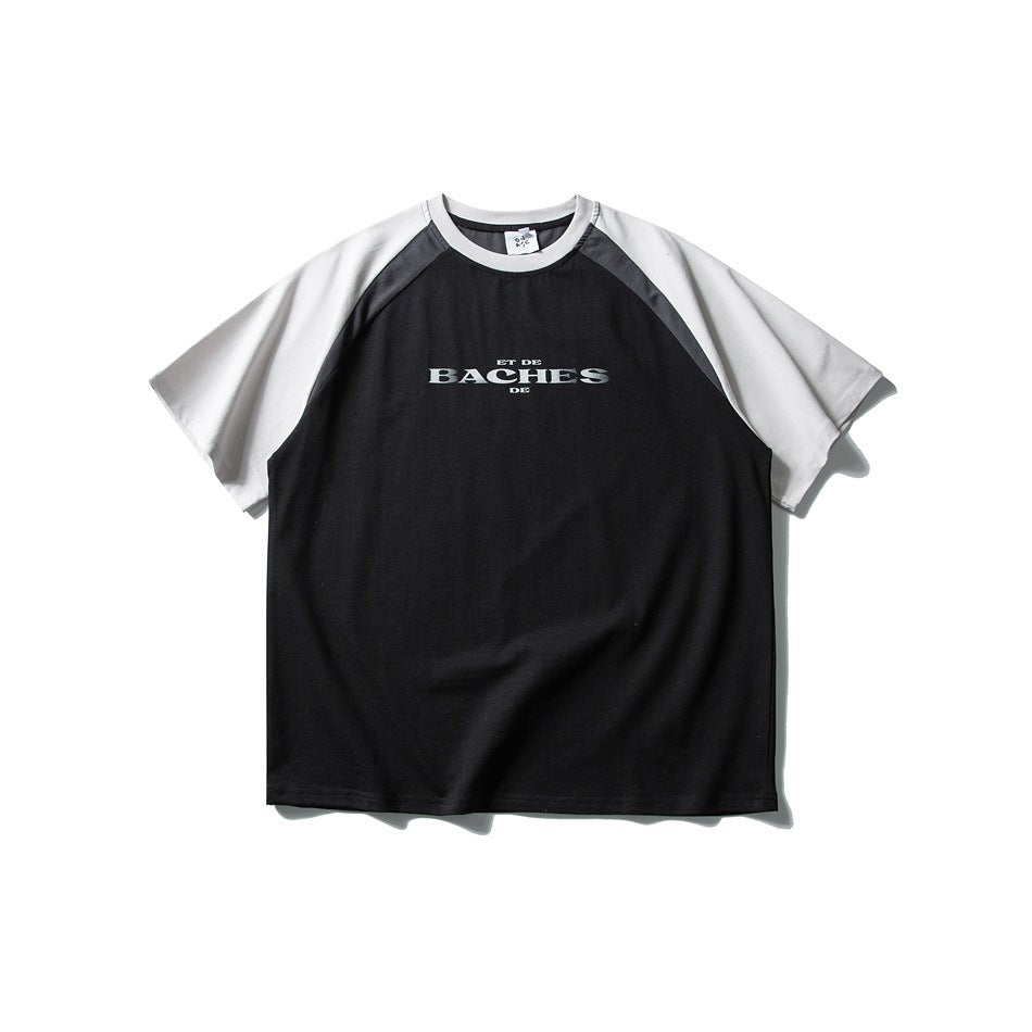 Front of black raglan T-shirt with light gray sleeves, dark gray shoulder panels and small chest text print