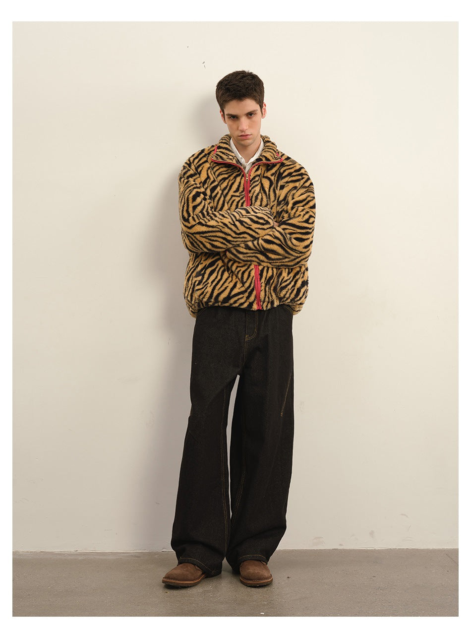 Full-length model wearing a tan-and-black tiger-stripe zip fleece jacket with red trim and loose black jeans.