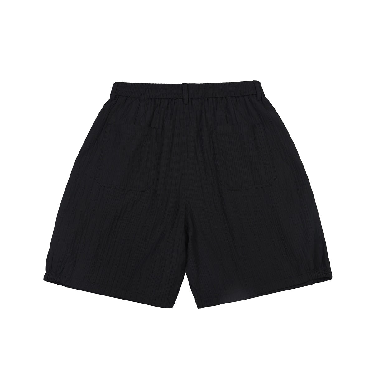 Back view of black textured shorts with two back patch pockets, elastic waistband and gathered hems