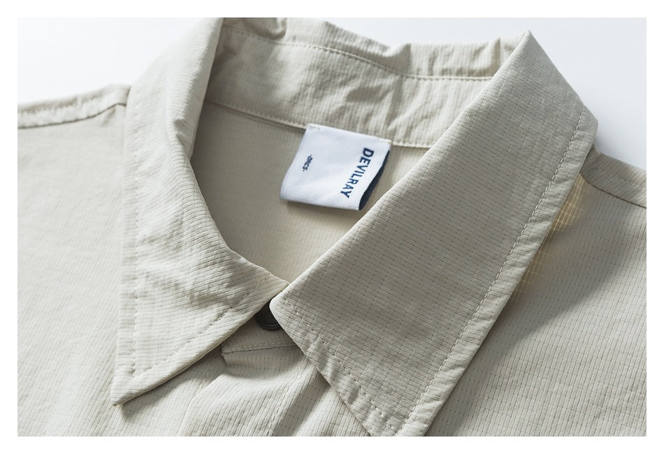 Close-up of the off-white shirt's pointed collar, stitching, and sewn-in DEVILRAY label.
