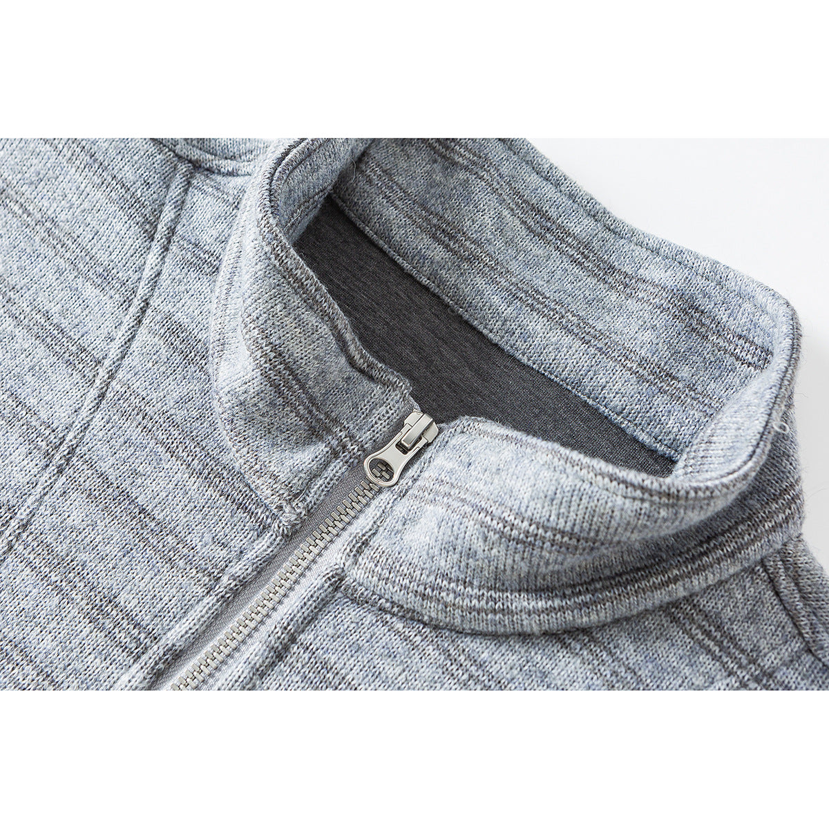 Close-up of a light gray marled pullover's stand collar and silver quarter-zip closure.