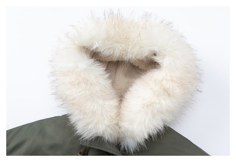 Close-up view into the cream faux-fur-lined hood of an olive-green jacket.