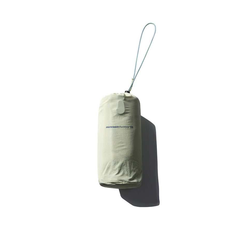 Pale yellow-green drawstring stuff sack with a cord loop and small dark branding, isolated against white.