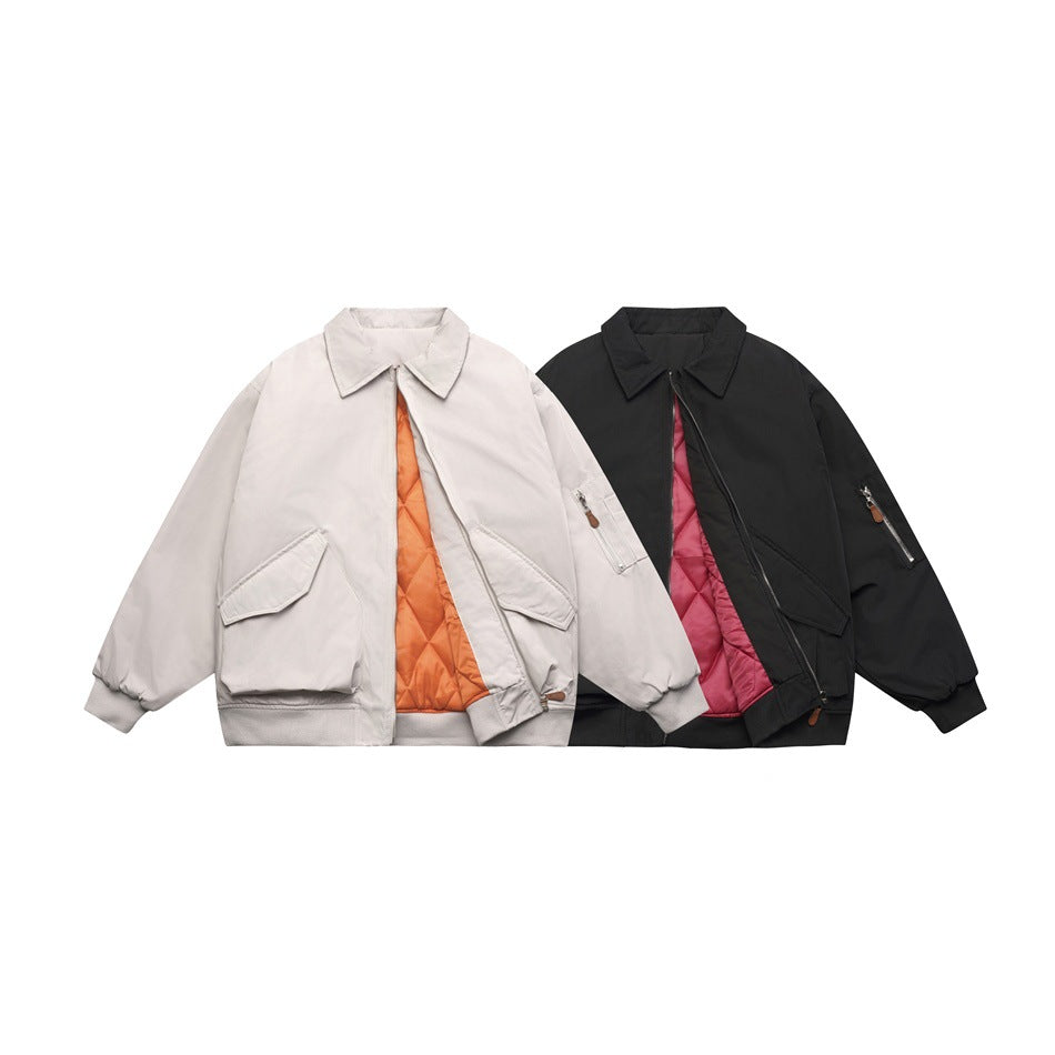 Front view of pale gray and black collared jackets with contrasting orange and pink quilted linings.