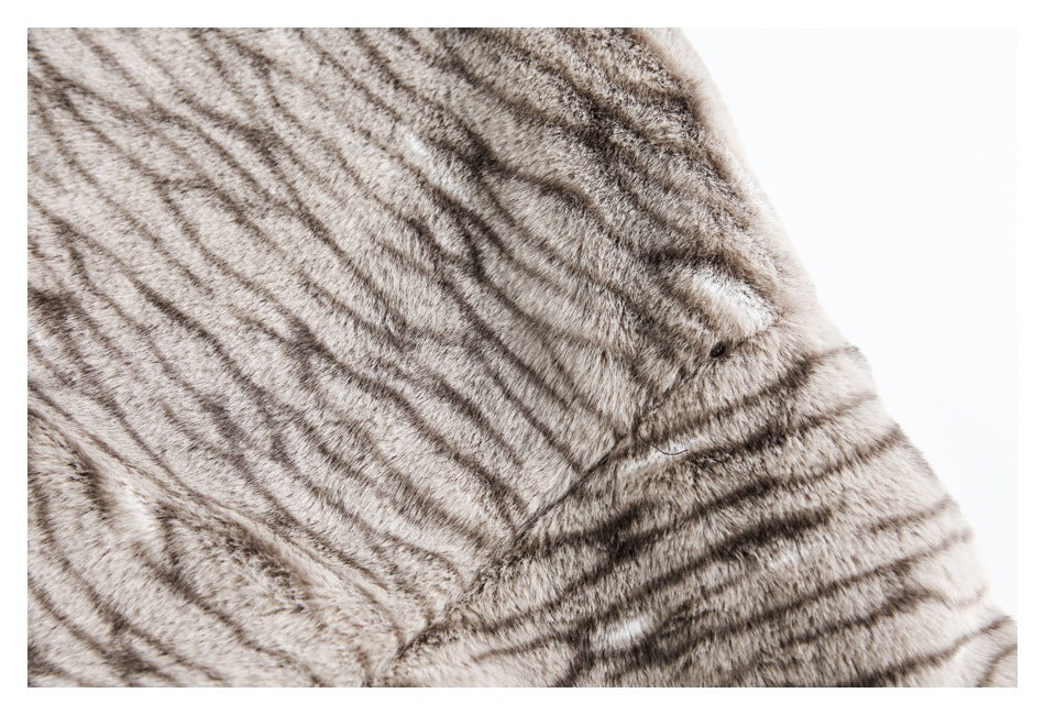 Close-up of gray and beige striped faux-fur lining with a stitched seam.