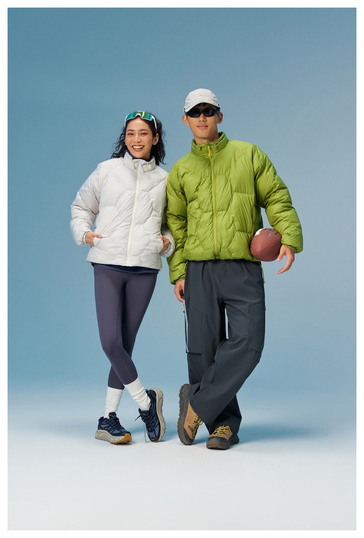 Two models wearing white and lime-green quilted zip jackets with high collars, shown together.