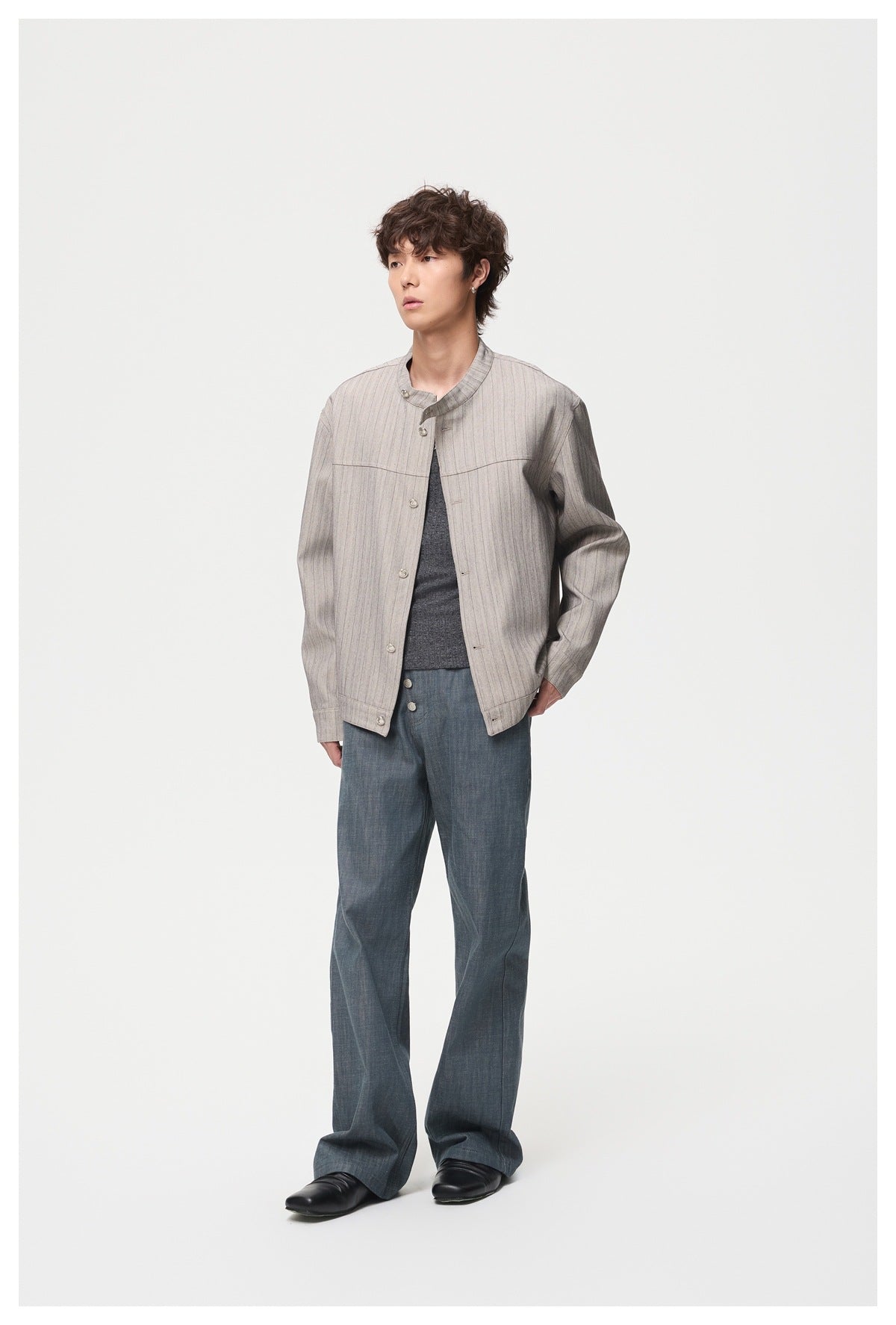 Model in gray striped stand-collar jacket with dark gray top and wide-leg pants, angled three-quarter view
