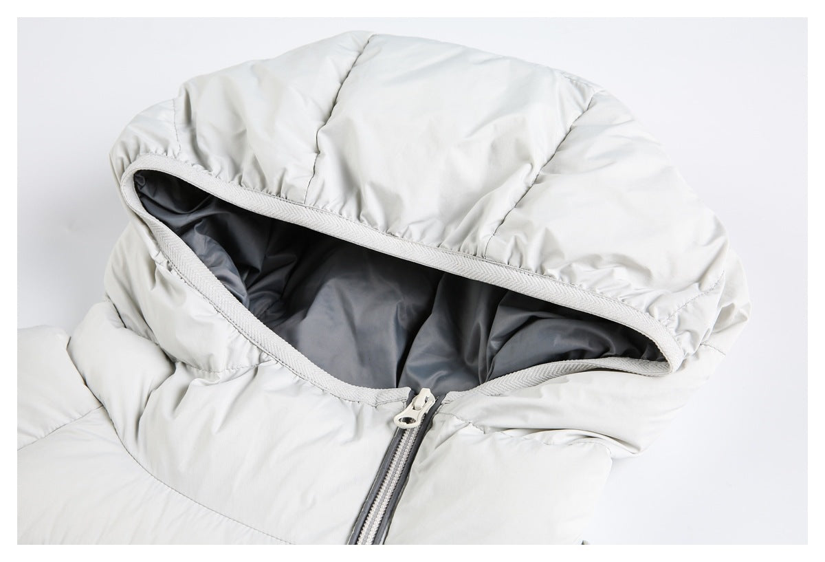 Close-up of a light gray puffer jacket hood, dark lining, and front zipper.