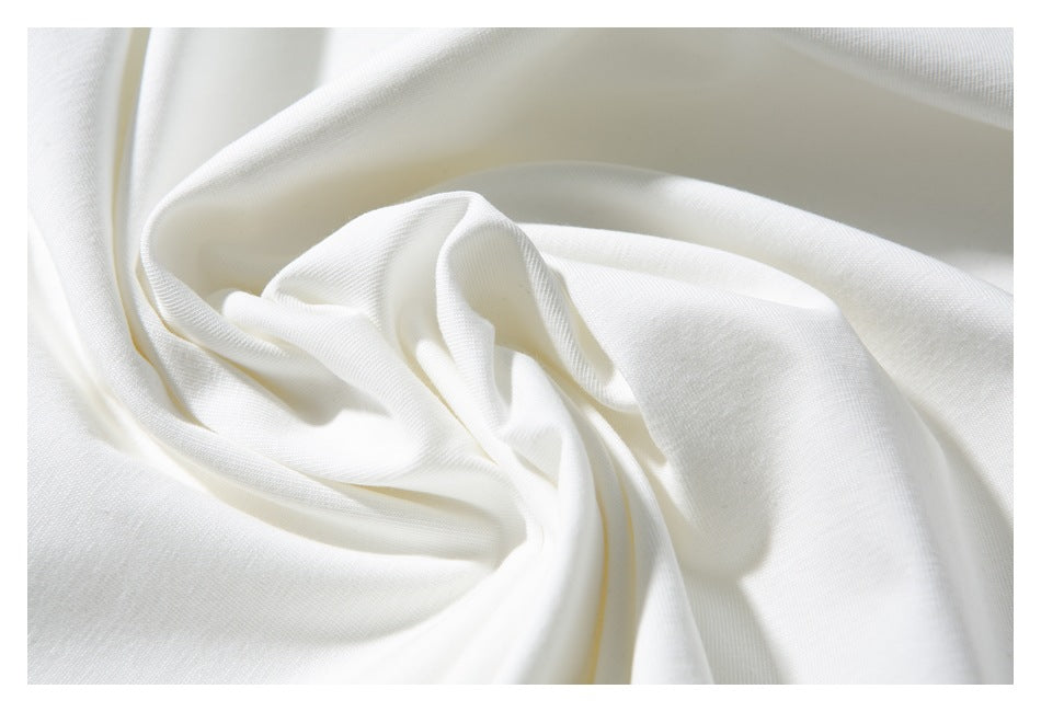 Close-up of softly folded white shirt fabric.