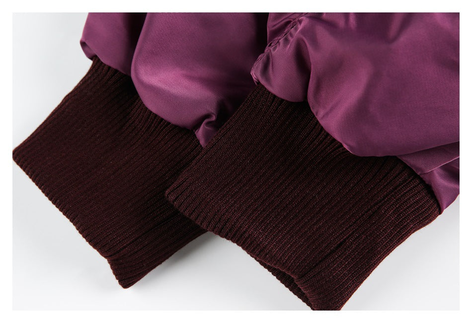 Close-up of the plum jacket's dark burgundy ribbed cuffs.
