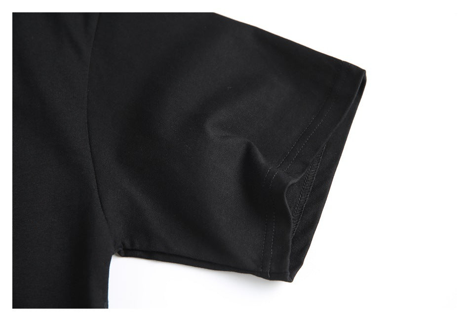 Close-up of the short sleeve and stitched cuff of a black shirt.
