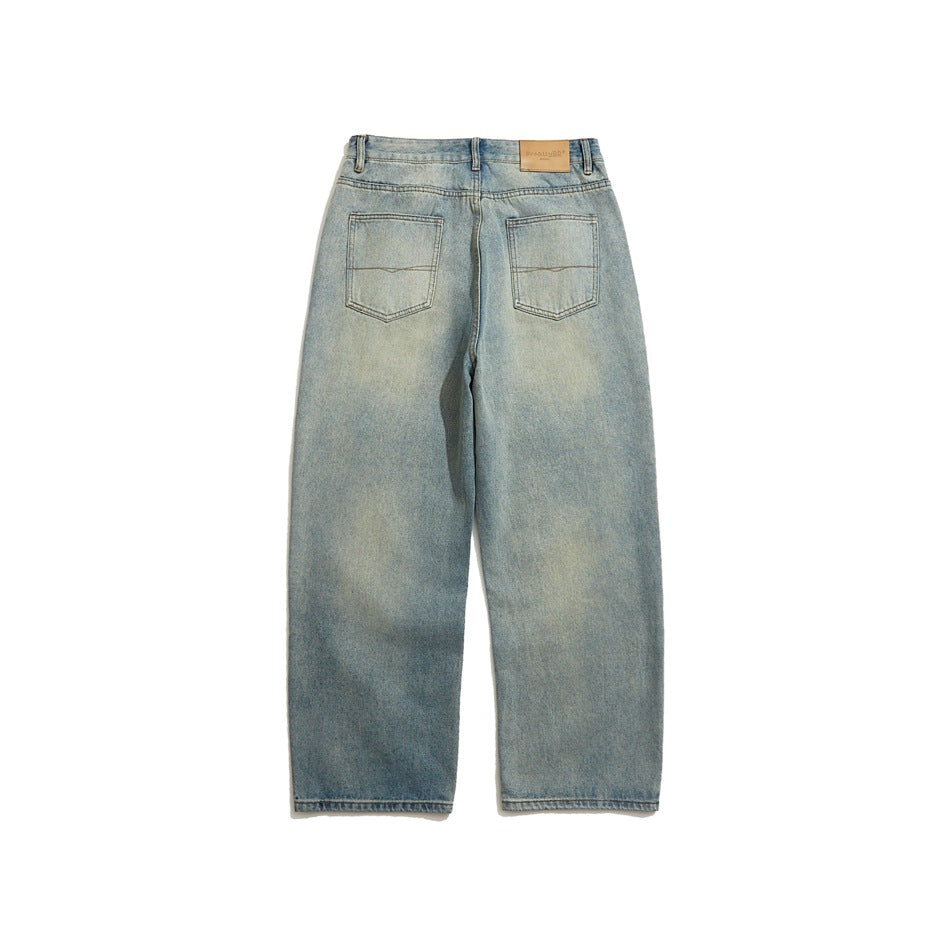 Back of light blue faded wide-leg jeans with two patch pockets and a leather-look waistband patch