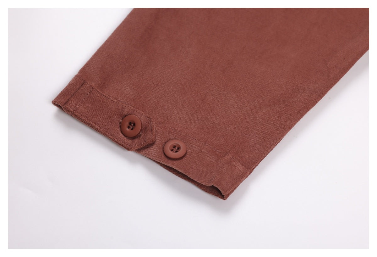 Close-up of a rust-brown shirt sleeve cuff with two matching buttons.