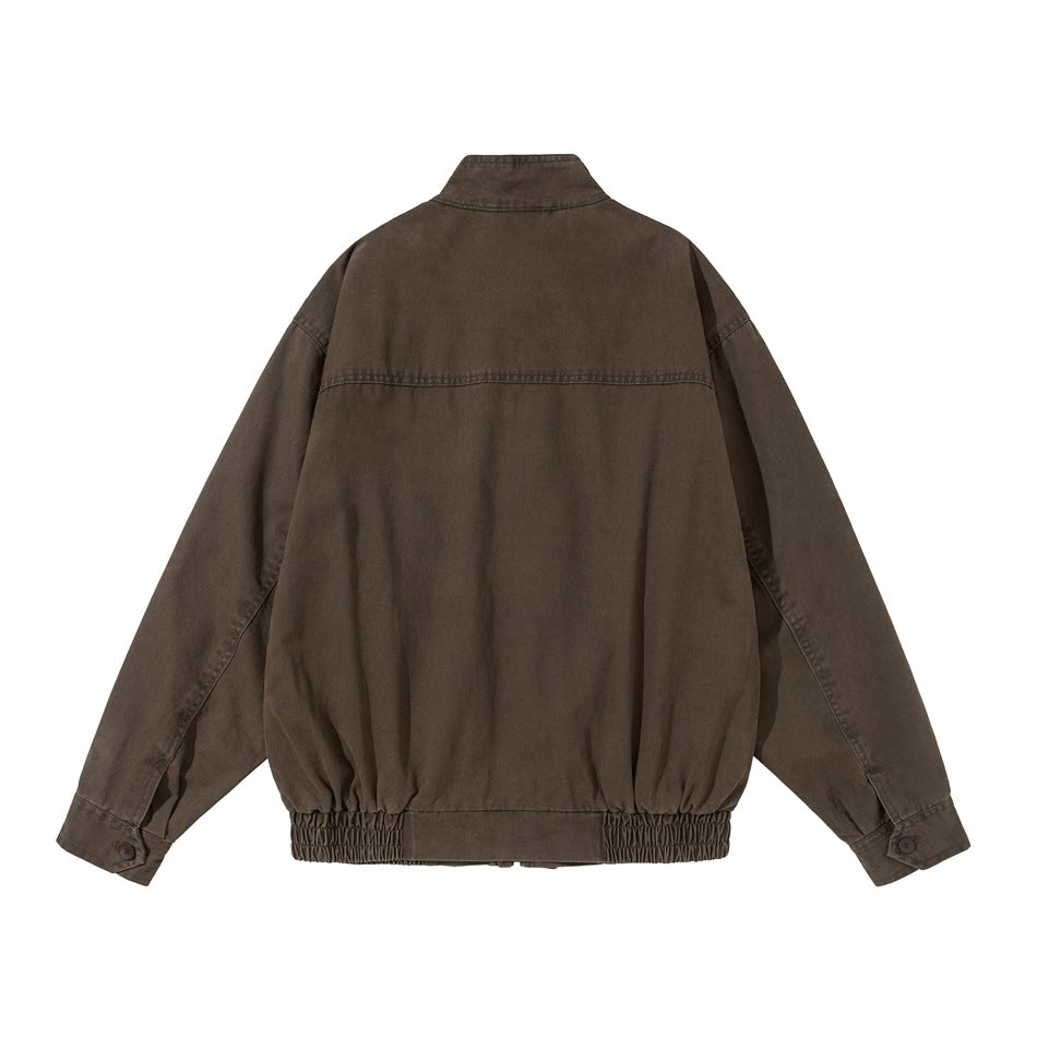 Back view of brown washed jacket with stand collar, yoke seam, button cuffs and elastic hem band