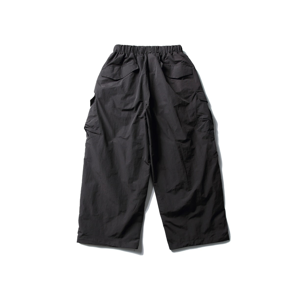 Back view of black wide-leg cargo pants with elastic waistband, back flap pockets and side cargo pockets