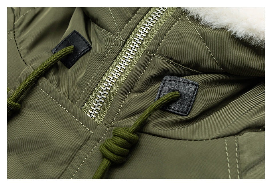 Close-up of the olive parka's metal front zipper and adjustable hood drawcords.