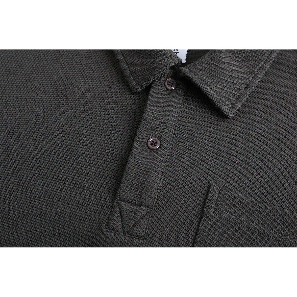 Close-up of a charcoal long-sleeve polo shirt showing its collar, buttons, placket, and chest pocket.