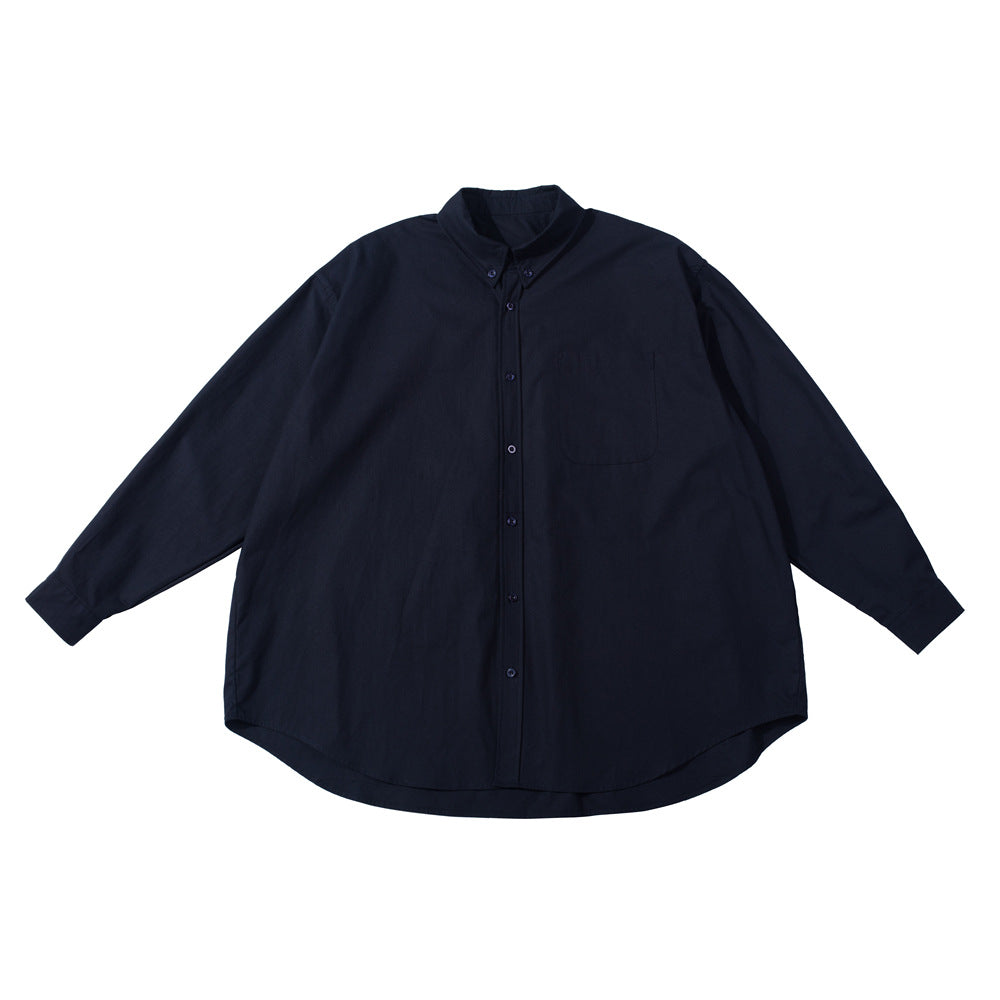 Navy blue oversized long-sleeve button-down shirt with chest pocket, flat lay on white background