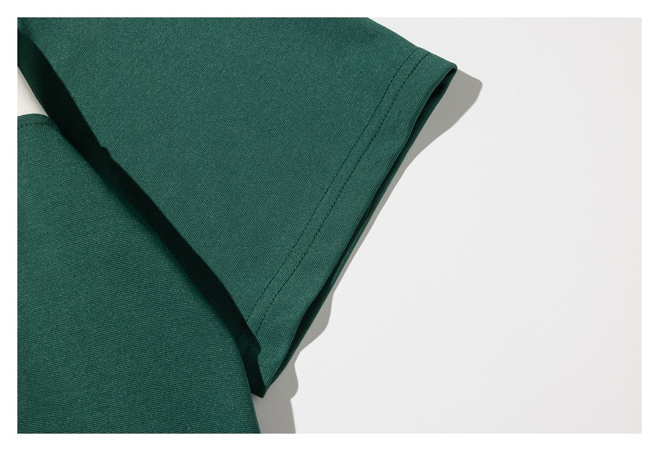 Close-up of the green short sleeve and stitched sleeve hem.