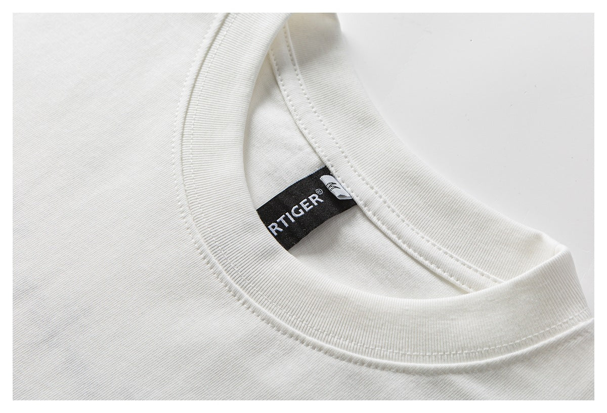 Close-up of a white crew-neck shirt collar and a black woven neck label.