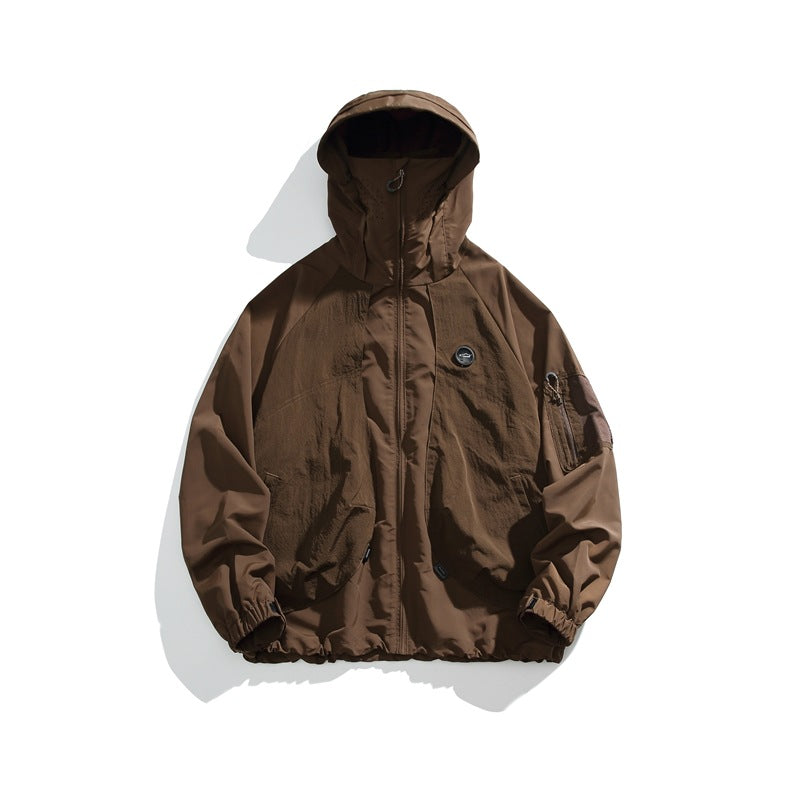Brown hooded zip-up lightweight jacket flat lay with chest patch and sleeve pocket
