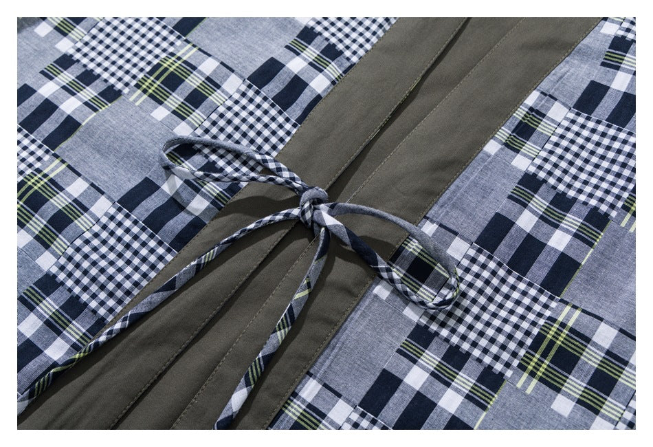 Close-up of an olive front panel and tied plaid belt against blue, white, and lime patchwork checks.